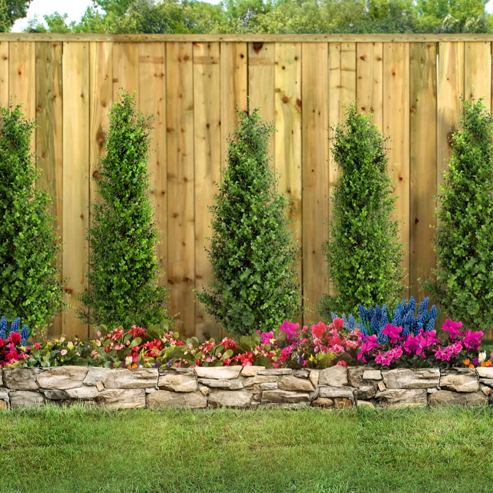 tree with retaining wall and bed